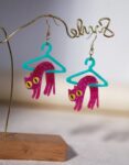 Material: transparent plastic “polymethyl methacrylate” Models Type: Shiny pink cat hanging on a clothes hanger